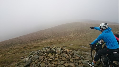 Mountain bikers navigating through fog